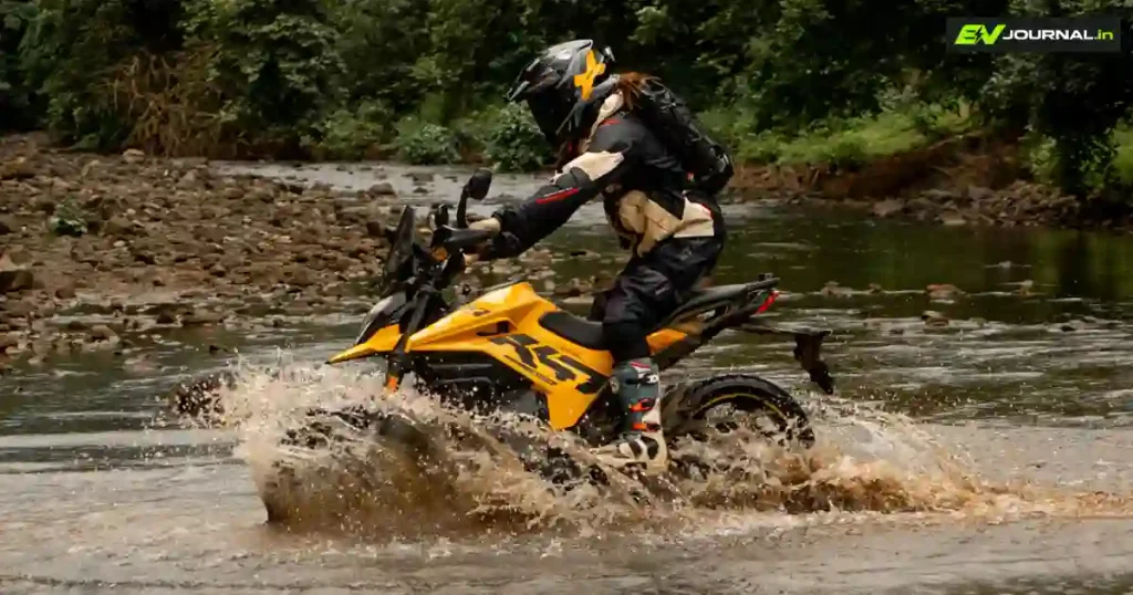 Rider taking the Ultraviolette X-47 Venom electric motorcycle through a shallow water crossing
